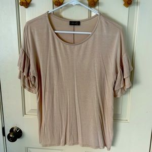 Cream colored women’s top with ruffle sleeves